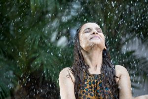 young woman enjoying rain