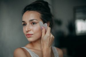 a girl is doing face massage