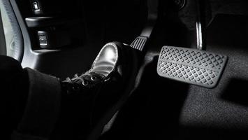 Close Up The Foot Pressing Foot Pedal Of A Car To Drive Ahead Photo