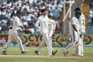 Pune: NZs Mitchell Santner celebrates with teammates after wicket of Rohit Sharma. Credit: PTI