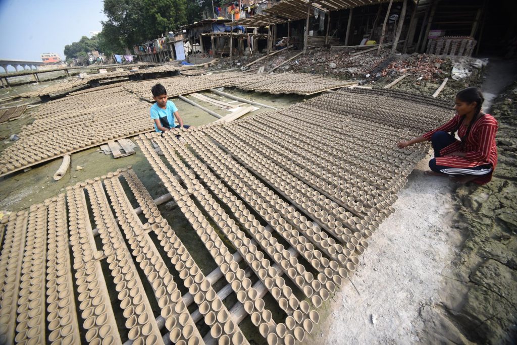 Women Puts Earthen Lamps For Drying In The Sun Ahead Of Diwali Festival 11