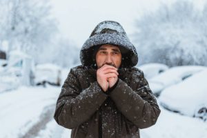 man shivering in cold