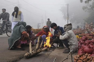 people sitting near a bonfire