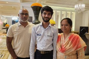 Gukesh with his parents.