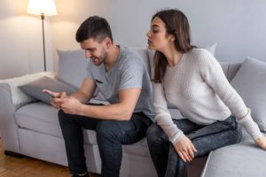 man using smartphone and a girl looking at it