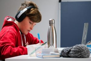 kid in red hoodie studying